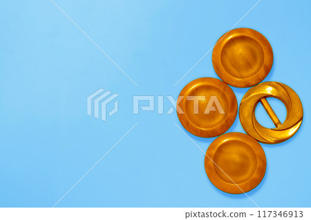 Orange copper ginger wooden circles buttons on blue. Elements, art decoration Orange copper ginger wooden circles buttons on blue. Elements, art decoration 117346913
