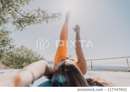 Woman Exercising on a Rooftop with a Stunning View Woman Exercising on a Rooftop with a Stunning View 117347602