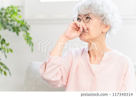 Senior woman with stuffy nose Senior woman with stuffy nose 117348314