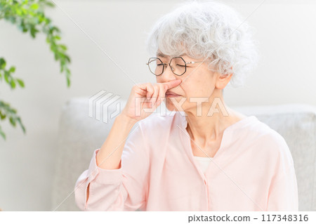 Senior woman with stuffy nose Senior woman with stuffy nose 117348316