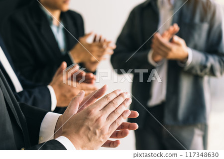 Diverse male and female audience giving round of applause to express respect and gratitude to speaker. Diverse male and female audience giving round of applause to express respect and gratitude to speaker. 117348630