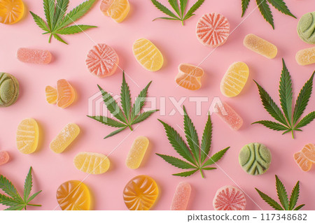 Assorted CBD Gummies with Hemp Leaves on Pink Background - Cannabis Edibles Assorted CBD Gummies with Hemp Leaves on Pink Background - Cannabis Edibles 117348682
