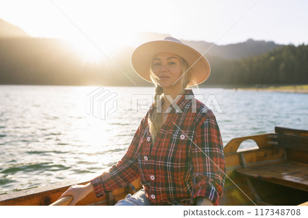 Portrait of a young woman rowing a boat on a spring day in Durmitor National Park in Montenegro 117348708