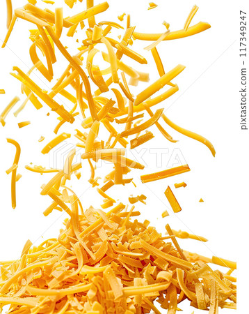 Close up of grated cheddar cheese falling and piling up on white background, capturing dynamic motion with cheese shreds in mid air. Vibrant yellow color of shredded cheese pieces. Ai generation 117349247