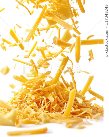 Close up of grated cheddar cheese falling and piling up on white background, capturing dynamic motion with cheese shreds in mid air. Vibrant yellow color of shredded cheese pieces. Ai generation 117349249