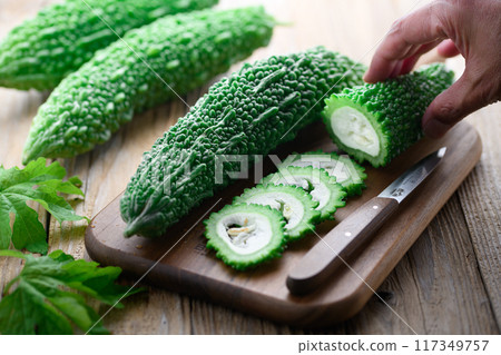 Image of cut summer vegetable bitter melon (bitter melon) 117349757