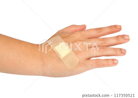 medical plaster or patch on hand isolated on the white 117350521