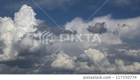 View of white fluffy clouds over blue sky. View of white fluffy clouds over blue sky. 117350774