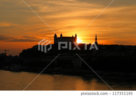 Bratislava, the capital of Slovakia in Central Europe - Bratislava Castle and sunset sky on a rocky hill on the Danube River 117351195