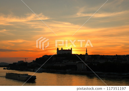 Bratislava, the capital of Slovakia in Central Europe - Bratislava Castle and sunset sky on a rocky hill on the Danube River 117351197