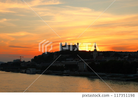 Bratislava, the capital of Slovakia in Central Europe - Bratislava Castle and sunset sky on a rocky hill on the Danube River 117351198