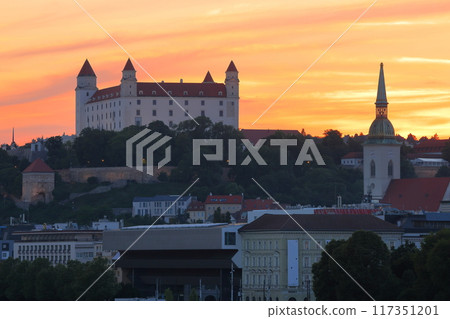 Bratislava, the capital of Slovakia in Central Europe - Bratislava Castle and sunset sky on a rocky hill on the Danube River 117351201