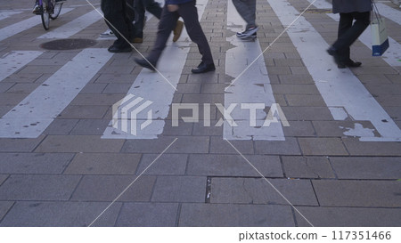 Crowd of people walking on street over zebra crossing or pedestrian crossing at shopping area and department stores on street in Osaka District, Japan , urban city of downtown. 117351466
