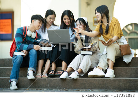 Group of students studying on campus outdoors 117351888