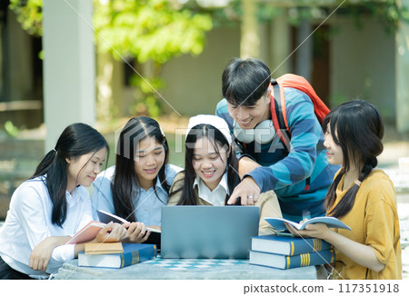 Group of students studying on campus outdoors 117351918