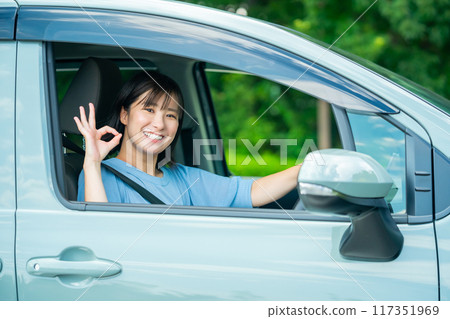 A woman driving a car A woman going for a drive A woman driving a car A woman going for a drive 117351969