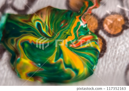 Abstract background of colored paint mixing in water, close-up	 117352163