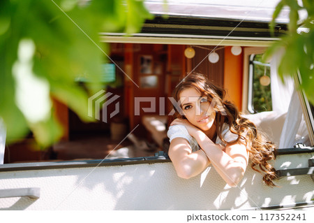Beautiful stylish bride near trailer. Camping season. Marriage. Happy newlywed woman. Beautiful stylish bride near trailer. Camping season. Marriage. Happy newlywed woman. 117352241