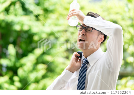 Businessman, extreme heat, heat stroke, water Businessman, extreme heat, heat stroke, water 117352264