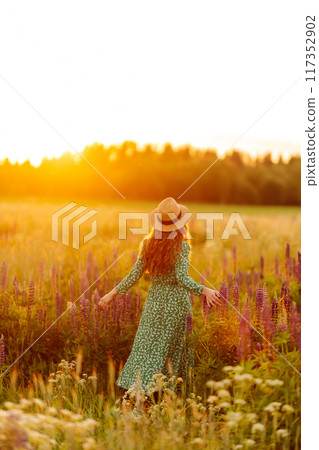 Beautiful woman in style dress on blooming fragrant lavender fields. Nature, vacation, lifestyle Beautiful woman in style dress on blooming fragrant lavender fields. Nature, vacation, lifestyle 117352902