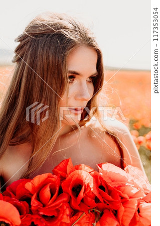 Woman poppies field. portrait happy woman with long hair in a poppy field and enjoying the beauty of nature in a warm summer day. Woman poppies field. portrait happy woman with long hair in a poppy field and enjoying the beauty of nature in a warm summer day. 117353054