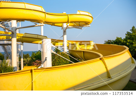 Water Slides, Water Park, Summer Fun - Yellow water slides at a water park on a sunny day. 117353514