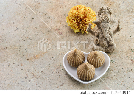 Ganesh Chaturthi Festival. Ganesha statue with modak sweets Ganesh Chaturthi Festival. Ganesha statue with modak sweets 117353915