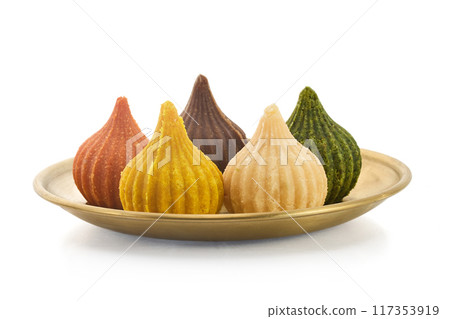 Ganesh Chaturthi Festival. Colorful Modaks Indian sweet dumpling Ganesh Chaturthi Festival. Colorful Modaks Indian sweet dumpling 117353919