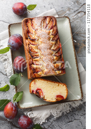 Italian Yogurt Plum Cake Torta di Susine closeup on the plate. Vertical top view Italian Yogurt Plum Cake Torta di Susine closeup on the plate. Vertical top view 117354118