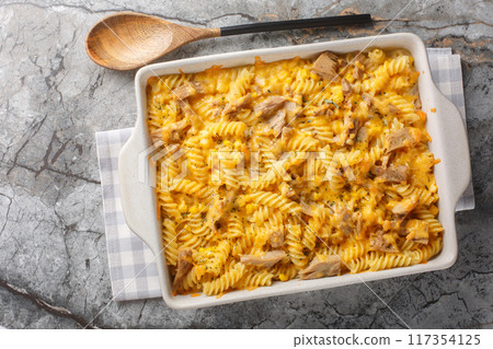 Pasta canned tuna baked with mornay sauce close-up in a baking dish. Horizontal top view 117354125