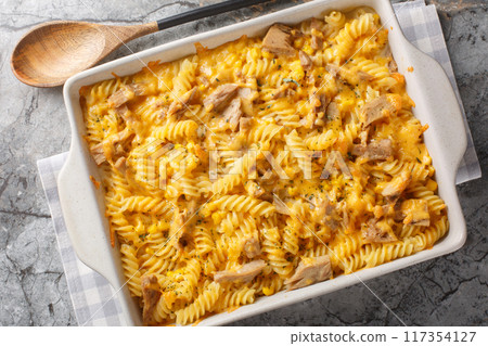 Tuna mornay is a classic Australian cheesy tuna pasta bake closeup on the baking dish. Horizontal top view 117354127