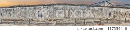 Panoramic image over a remaining part of the Berlin Wall in 2013. Panoramic image over a remaining part of the Berlin Wall in 2013. 117354446