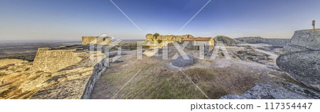 Panoramic image of the fortification above the historic town of Monsanto in Portugal during sunrise Panoramic image of the fortification above the historic town of Monsanto in Portugal during sunrise 117354447