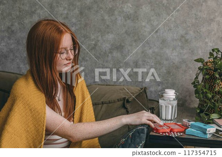 woman arranging her daily supplements, Home Health Monitoring, Ensuring Wellness from Comfort of Home woman arranging her daily supplements, Home Health Monitoring, Ensuring Wellness from Comfort of Home 117354715