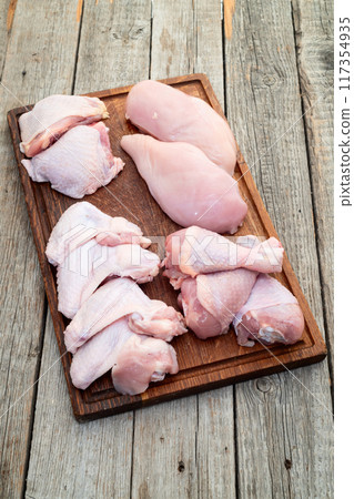 Raw mixed chicken meat parts  for cooking on rustic background 117354935