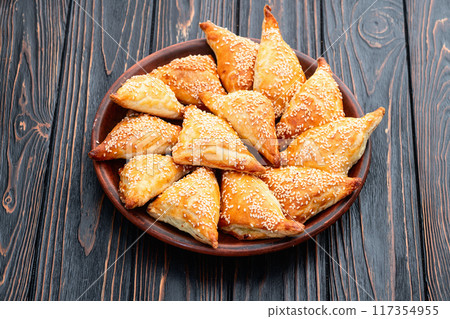 Homemade triangle puff pastry with meat on rustic background . Samosa 117354955