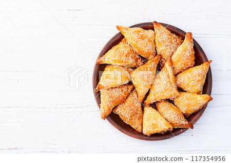 Homemade triangle puff pastry with meat on rustic background . Samosa Homemade triangle puff pastry with meat on rustic background . Samosa 117354956