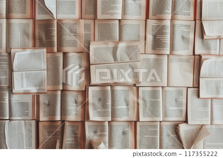 A flat lay of multiple open books with flipping pages, symbolizing learning and knowledge, on a wooden surface 117355222