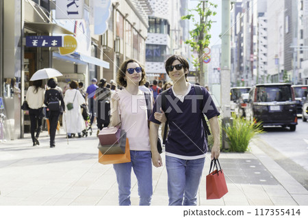 Inbound foreign tourist couple shopping in Ginza Inbound foreign tourist couple shopping in Ginza 117355414