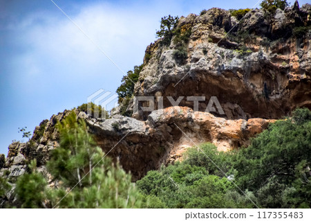Caves in the limestone mountains. Void in rock mountain. Caves in the limestone mountains. Void in rock mountain. 117355483