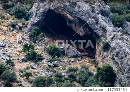 Caves in the limestone mountains. Void in rock mountain. Caves in the limestone mountains. Void in rock mountain. 117355484