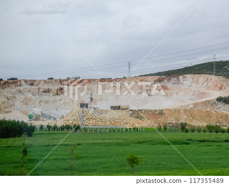 Marble quarry quarrying white marble in open pit 117355489