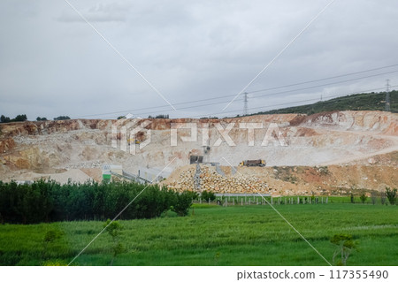 Marble quarry quarrying white marble in open pit 117355490