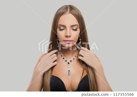 Healthy jewellery model woman wearing stylish gold earring and necklace  117355566
