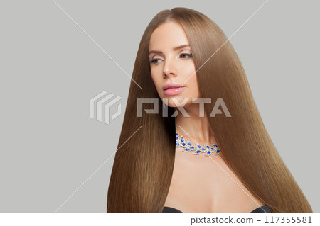 Good-looking jewelry woman with long healthy hair wearing glamour jewellery necklace.  117355581
