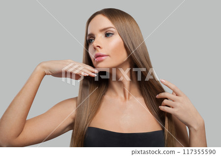 Beauty portrait of female model brunette with long hair and natural make-up posing isolated  117355590