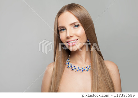 Lovely jewelry woman with long healthy hair wearing glamour jewellery necklace.  117355599