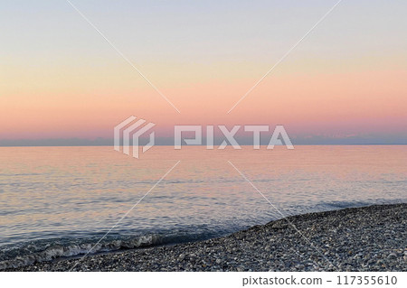 Tranquil nature background. Pastel pink and blue color sea and sky Tranquil nature background. Pastel pink and blue color sea and sky 117355610