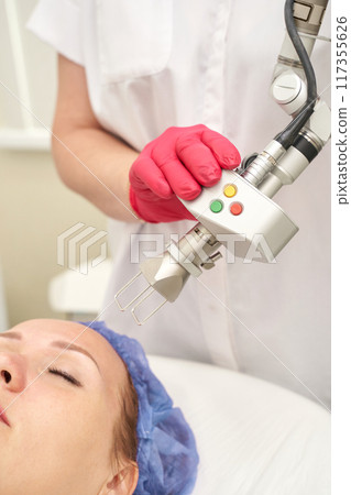 Face procedure. Professional dermatologist uses modern technology Face procedure. Professional dermatologist uses modern technology 117355626