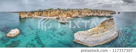 Panoramic drone picture over Praia do Marinha beach in Portuguese Algarve during daytime 117357307